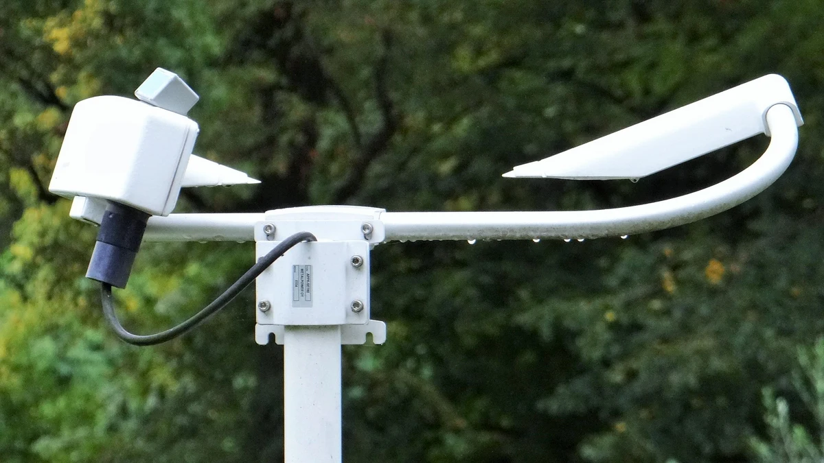 Outdoor meteorological scatterometer with water droplets on its sensor arm
